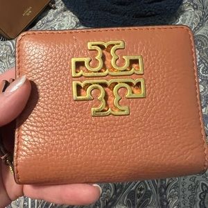 Apricot pink Tory Burch tri fold mini wallet.